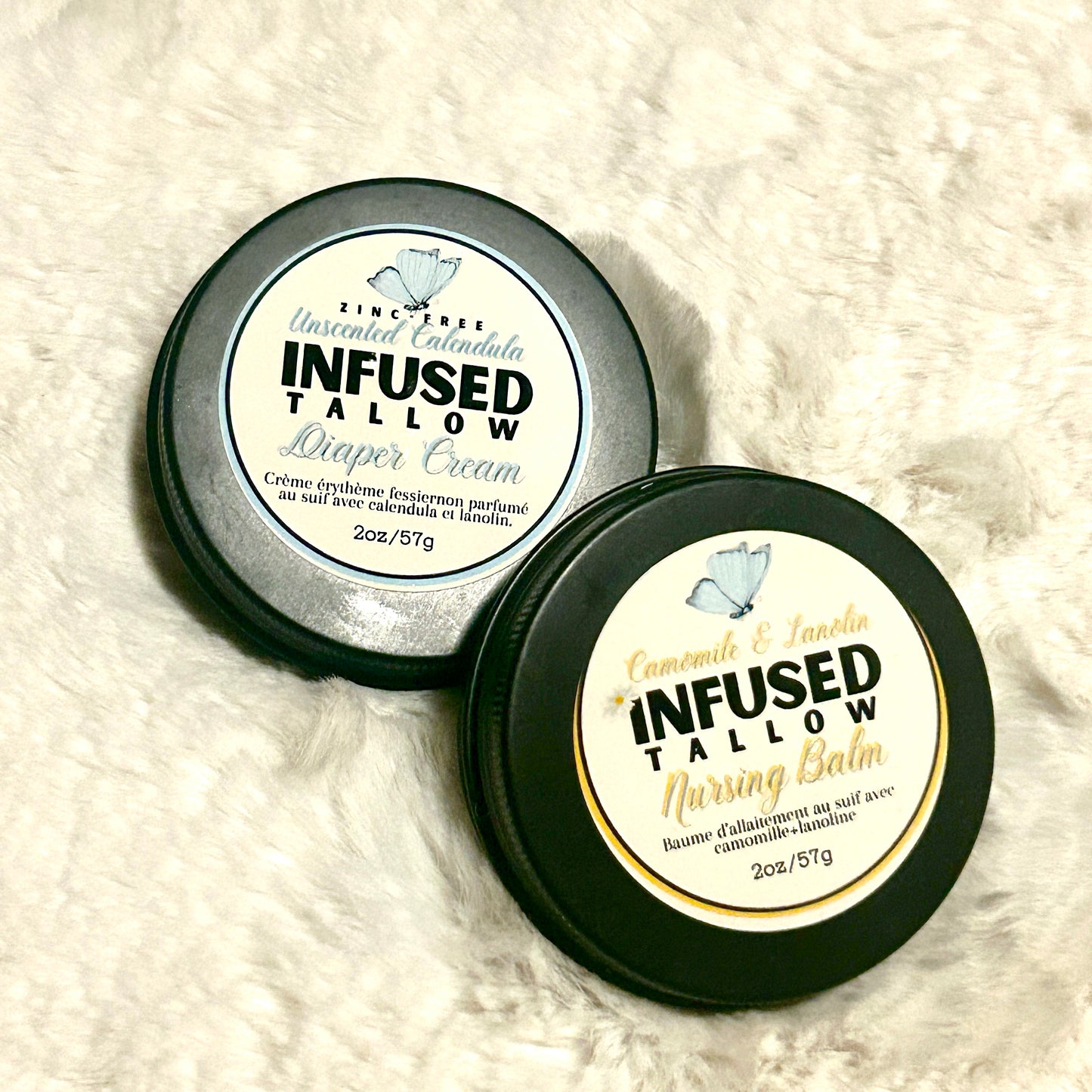 Two tins of 'Infused Tallow' products on a white fluffy background